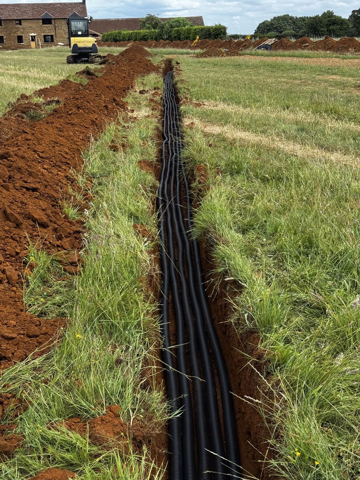 Cable trench running across a field to the plant room